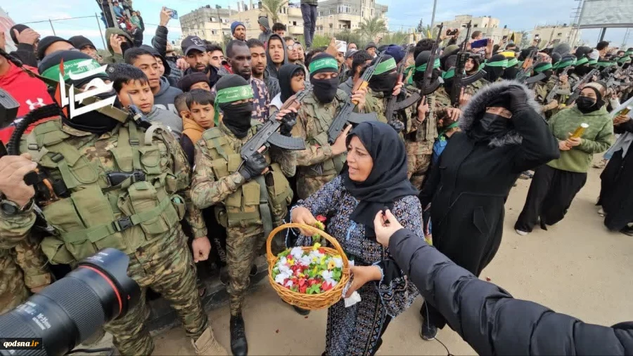 ریختن گل بر سر مجاهدان قسام از سوی  بانوی فلسطینی در مراسم تحویل اسرای اسرائیلی در دیر البلح در مرکز نوار غزه
 3