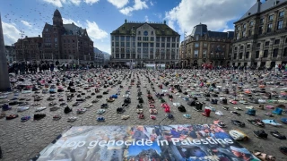 Children’s shoes and the names of Gaza’s slain journalists displayed in Amsterdam Square